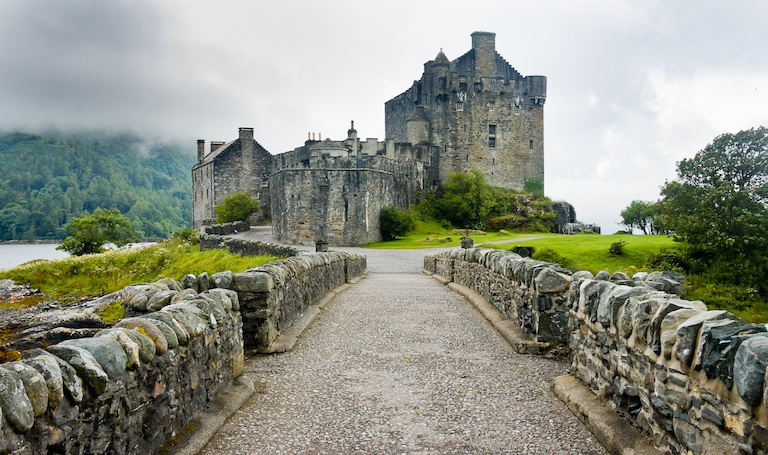 A castle in Scotland with a lake in the background