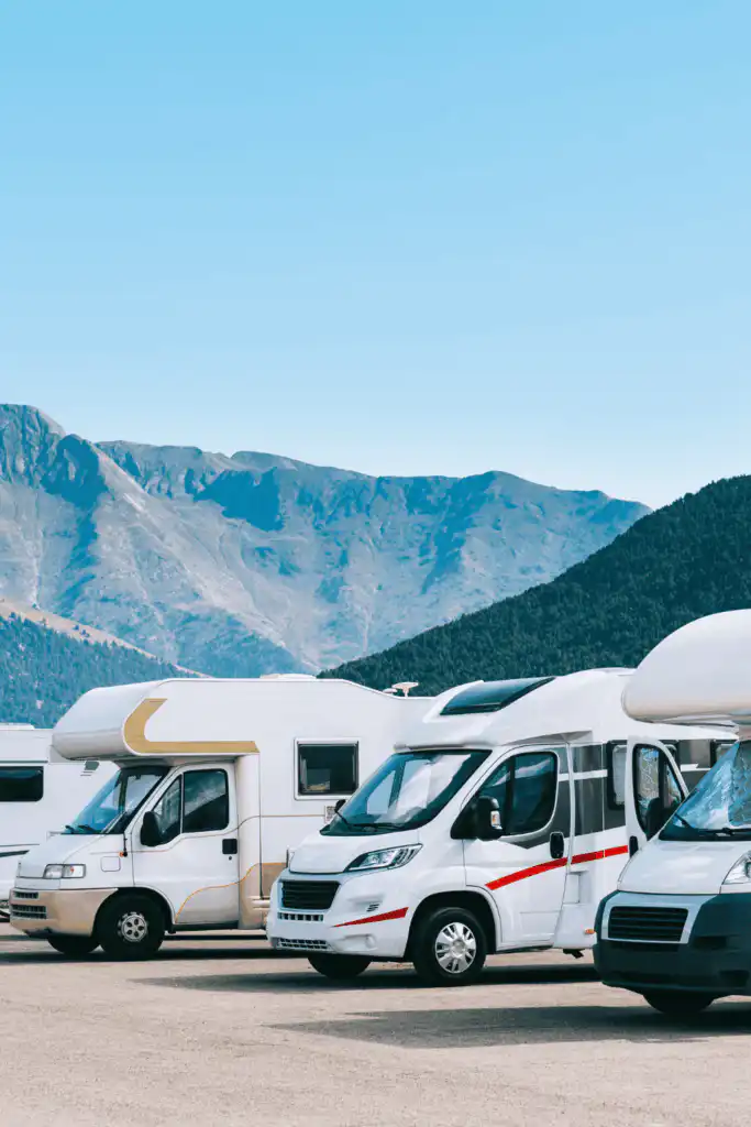 motorhomes lined up in a row in a carpark in Scotland