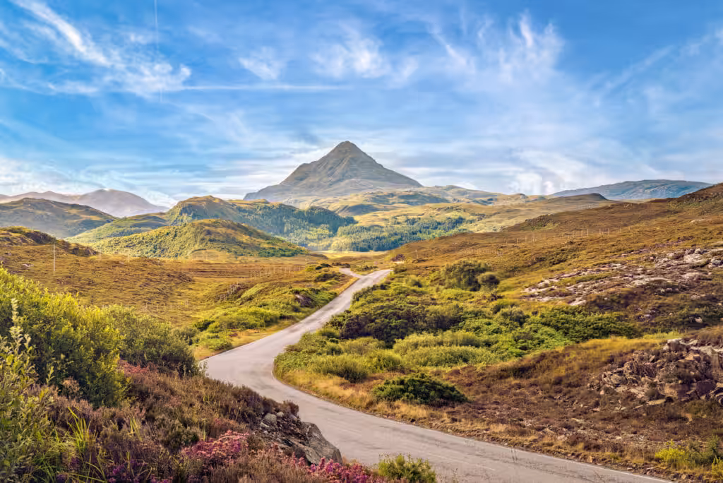 Grass fields with road and mountain