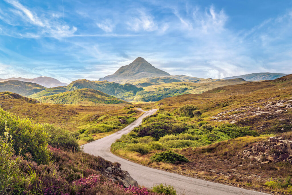 Grass fields with road and mountain
